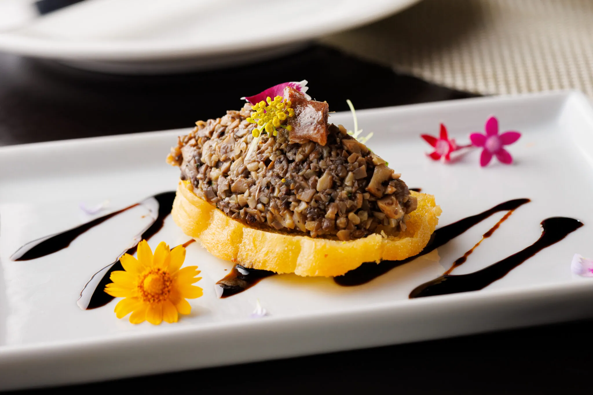 Close-up of the crunchy anchovy and mushroom bruschetta amuse bouche from the 137 pillars restaurant menu