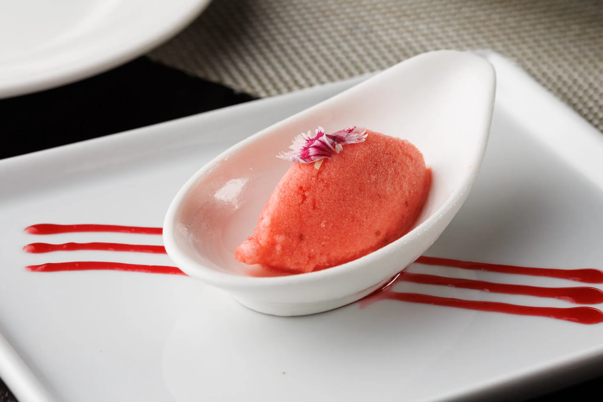 Sweet and tangy strawberry sorbet palate cleanser served in a martini glass