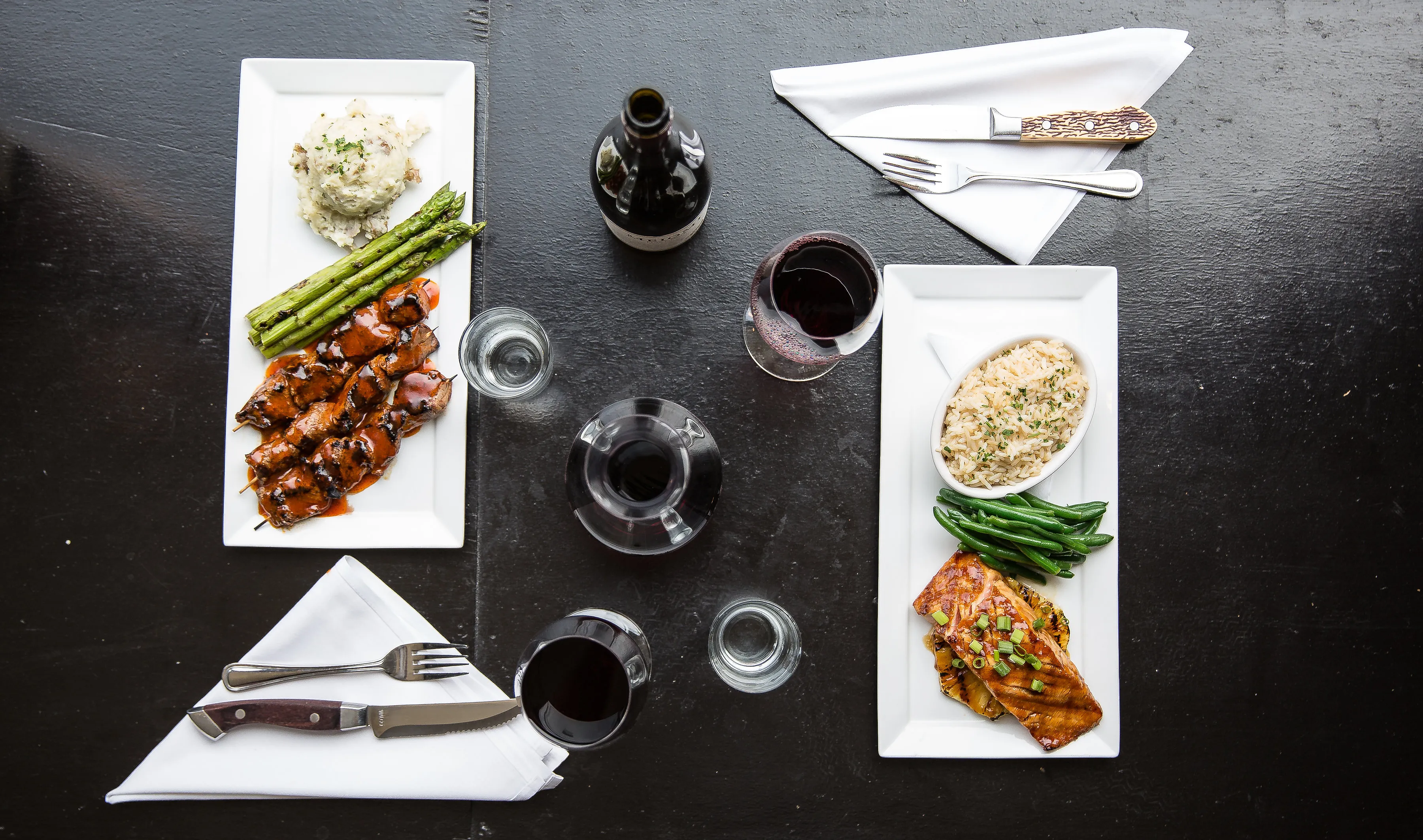 A close-up view of a steak and a seafood dish, showcasing the quality of the Diamonds restaurant menu offerings