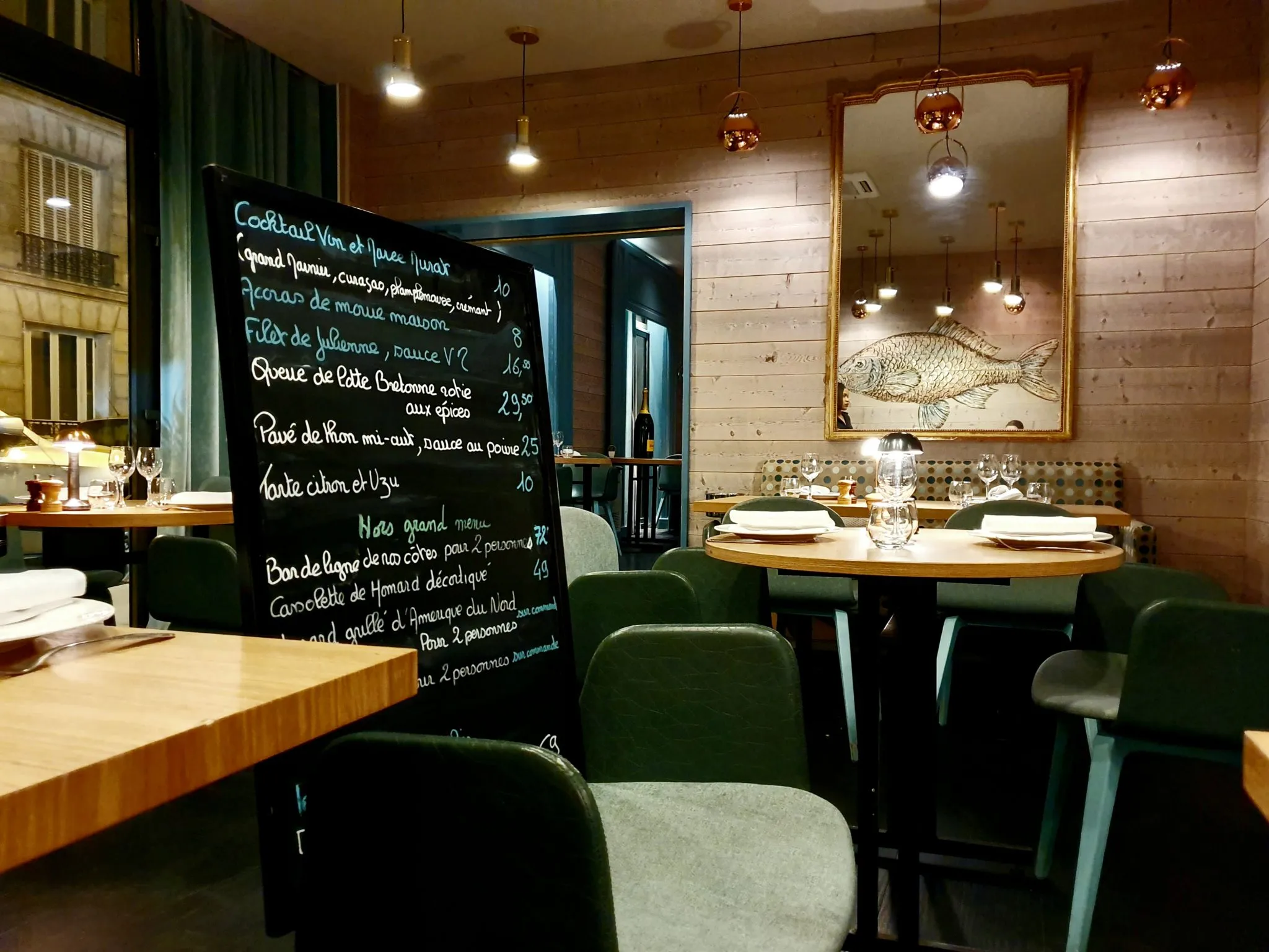 Another view of the elegant interior of Vin et Marée, highlighting the soft seating and cozy lighting central to the et restaurant menu experience