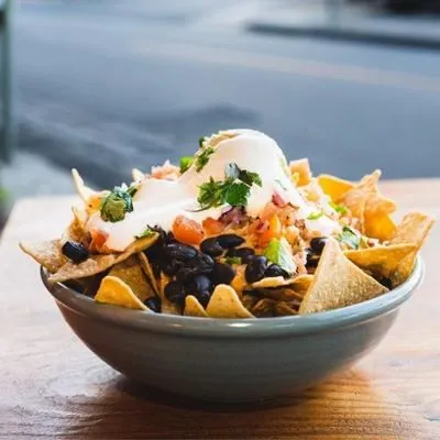 Loaded nachos with various toppings, a popular dish on the Si Senor Mexican restaurant menu