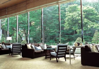 An elegant lounge area with comfortable seating and soft lighting, suggesting a sophisticated atmosphere.