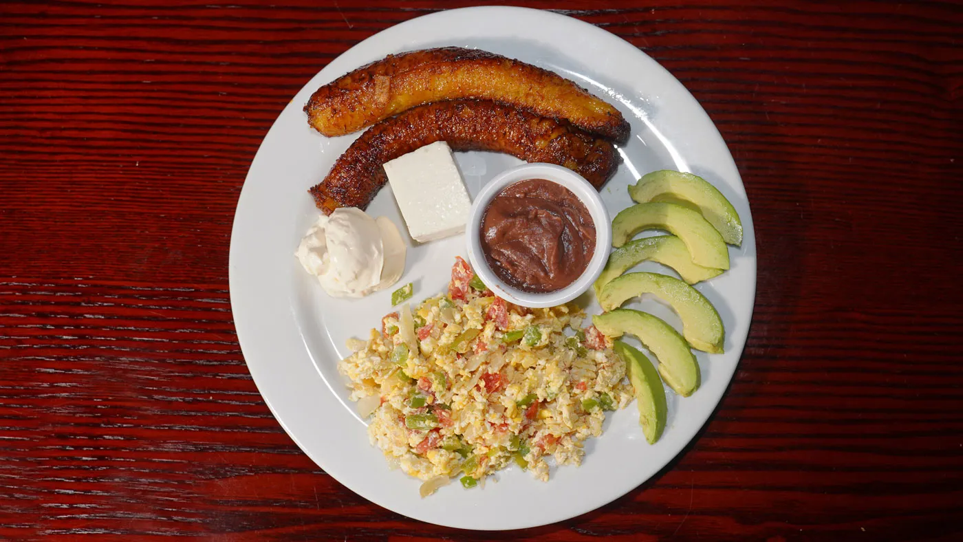 Scrambled eggs, fried plantains, and beans, a simple choice on the armenia restaurant menu