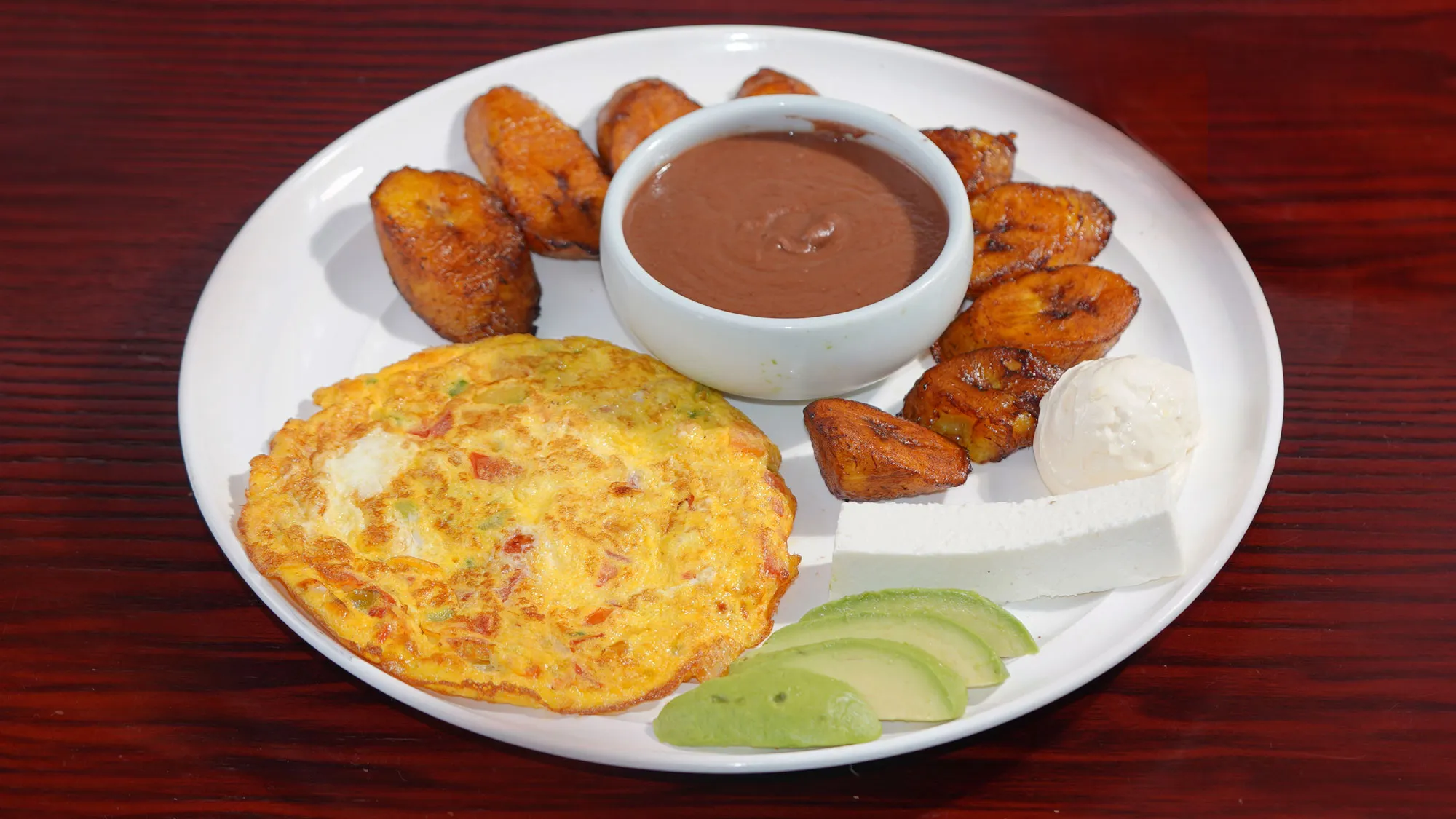 Eggs, plantains and beans arranged for the Salvadoran omelette on the armenia restaurant menu