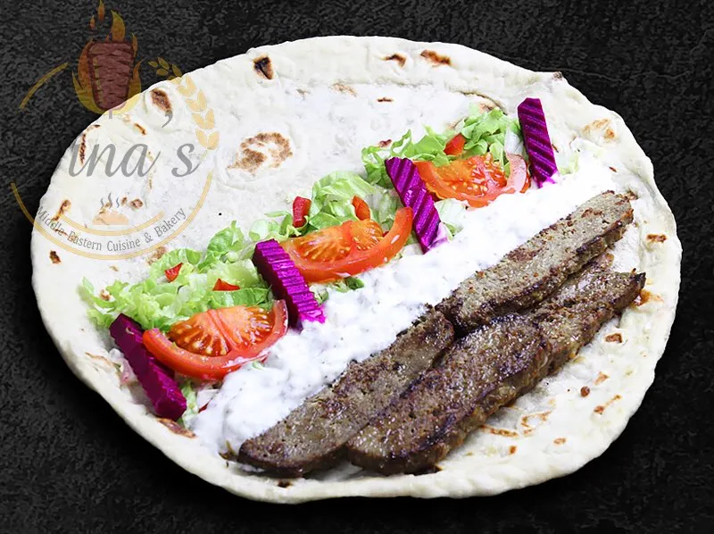 Classic Gyro wrap with seasoned lamb and beef, a popular choice from the dina's restaurant menu