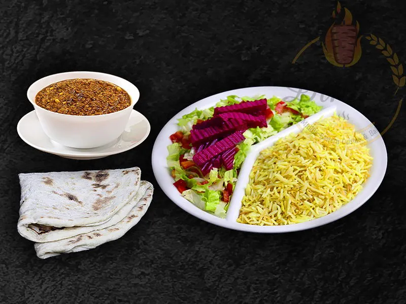 Hearty Qeema stew with beef and lamb, served with basmati rice, from the dina's restaurant menu