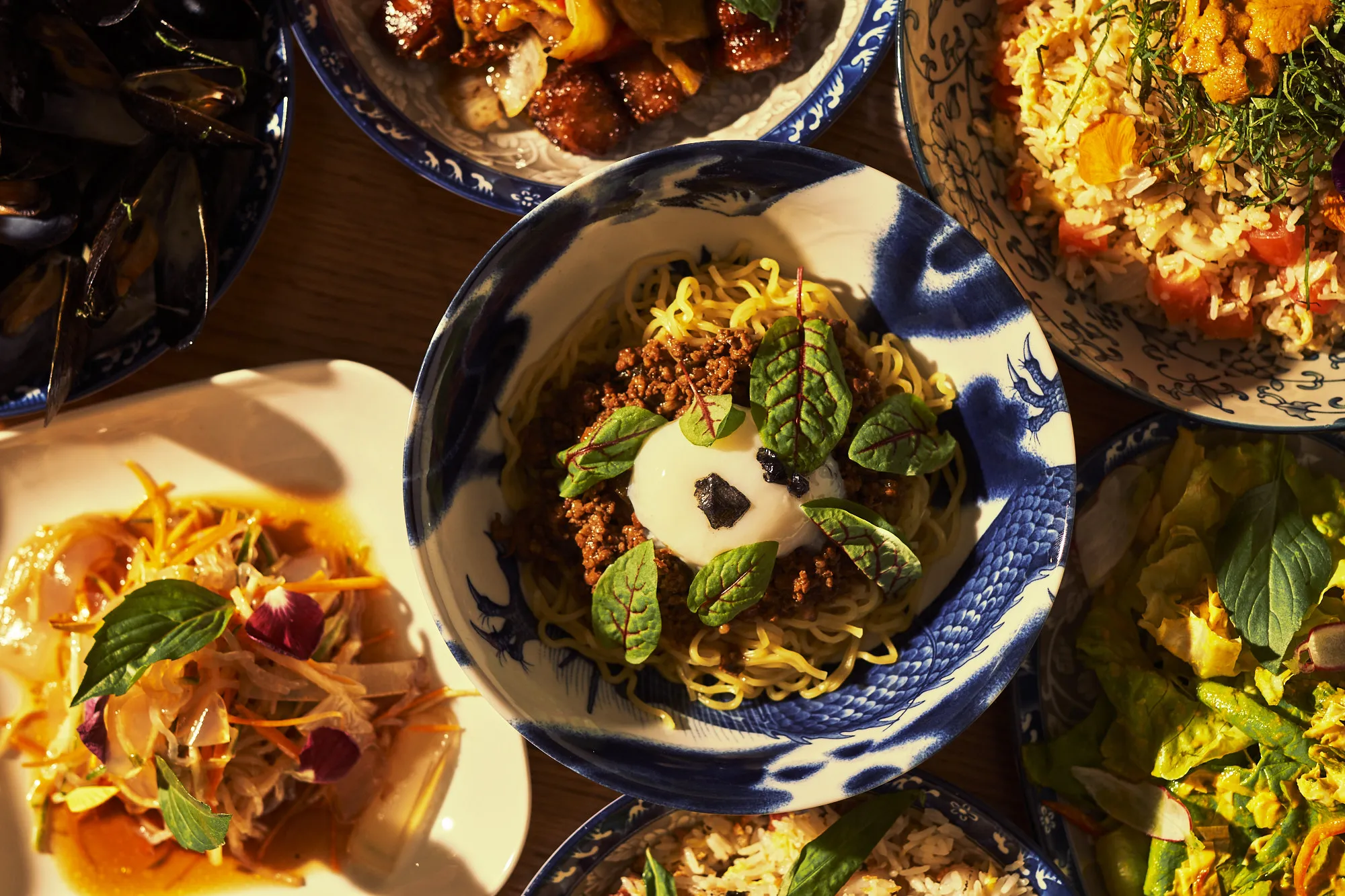 Assortment of innovative dishes demonstrating the diverse offerings on a unique Chinese restaurant menu, featuring both Chinese and Japanese culinary influences.