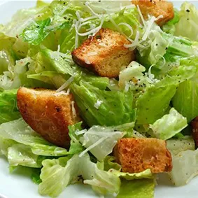 A classic Caesar salad with romaine, croutons, and Parmesan, a staple on the Marion restaurant menu.