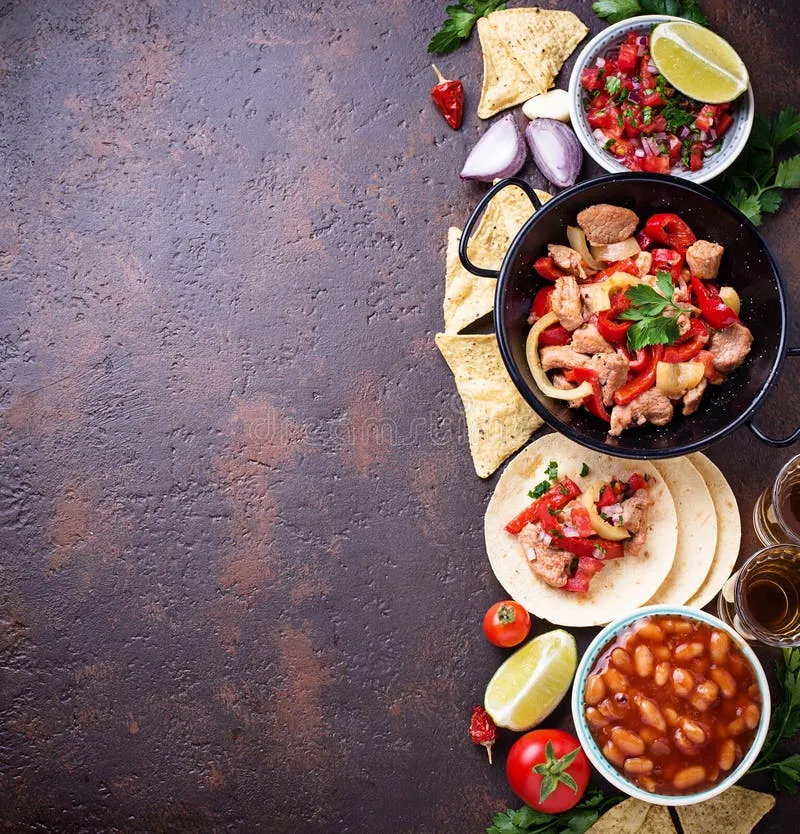 Overhead view of various Mexican food ingredients like salsa, tortillas, beans, and fajitas, essential components of a rich chili pepper restaurant menu.