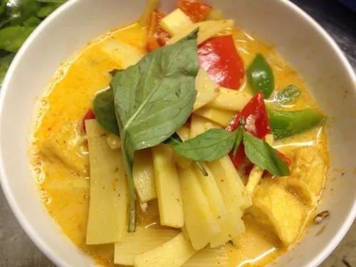 Four bowls of signature Siam Orchid curries: Red, Yellow, Green, and Masaman
