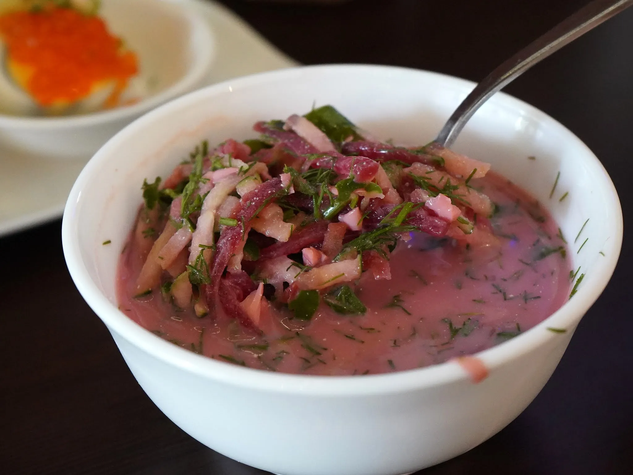 A serving of Ukrainian Borscht Soup with sour cream, a classic dish from a Russian menu restaurant