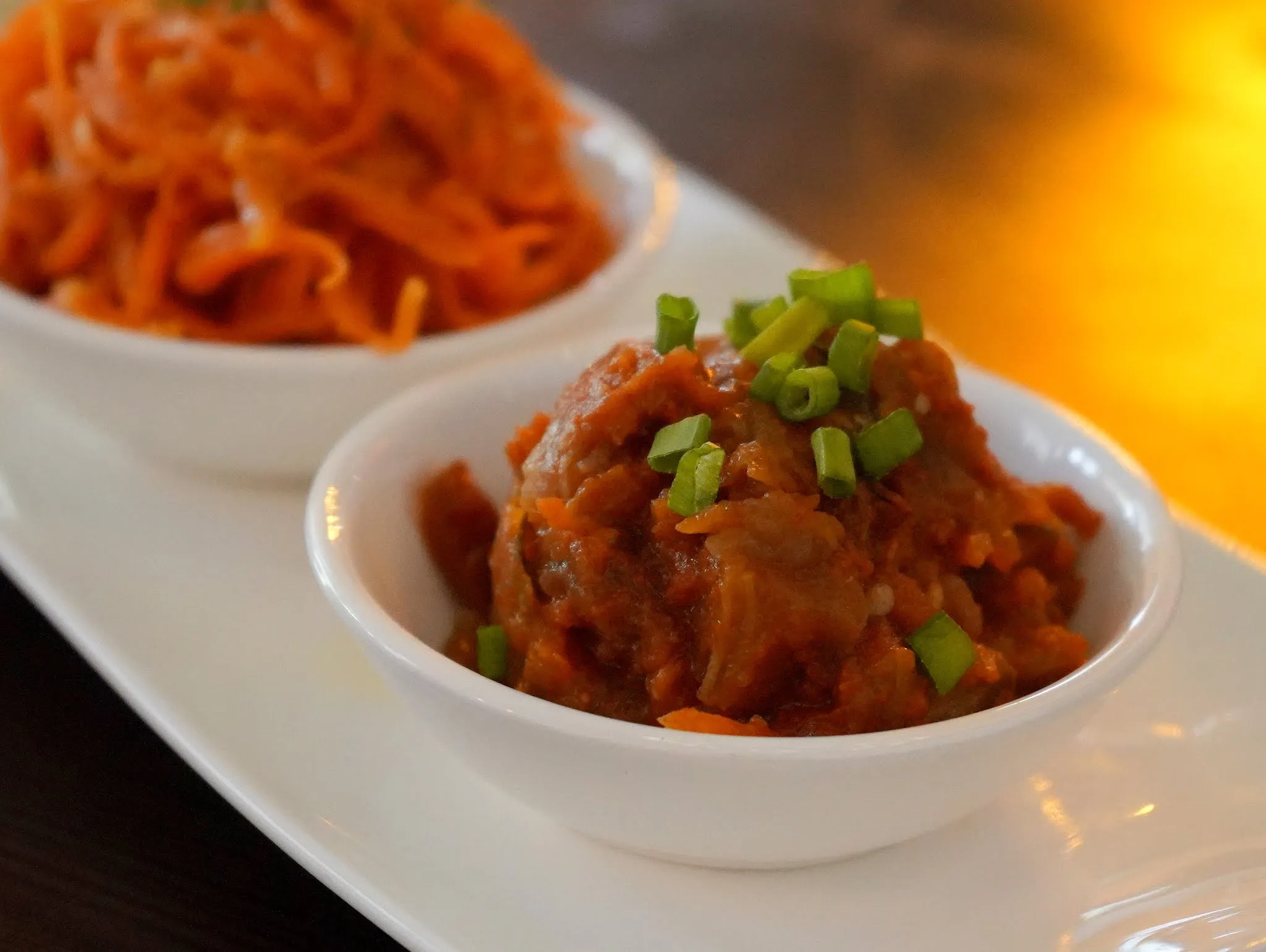 A plate of vibrant Spicy Carrot, a crunchy and zesty appetizer from a Russian menu restaurant