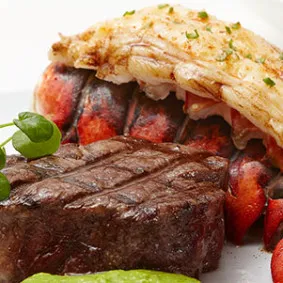 A luxurious pairing of Prime Filet Mignon with Lobster Tail, an unforgettable combination on the Marion restaurant menu.