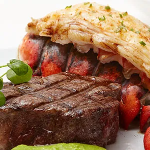 A luxurious surf and turf combination featuring a prime filet mignon paired with a whole lobster tail