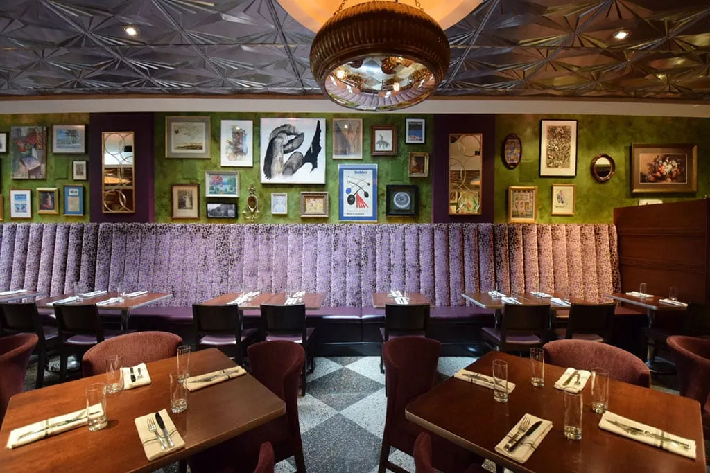Elegant dining room interior with a recreated tin ceiling at The Majestic restaurant in Alexandria