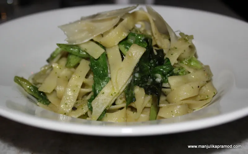 Homemade fettuccini with fresh basil, spring onion, broccoli, rocket and feta cheese