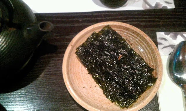 Dolsot Bibimbap with tofu and vegetables in a sizzling stone pot, ready to be mixed, highlighting the allintitle:kimchee restaurant menu's popular offerings.