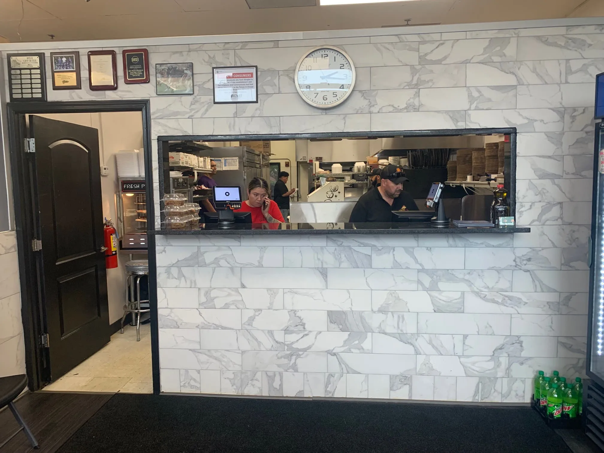 The newly renovated customer entrance of Niko's Pizzeria, inviting patrons to explore the unchanged niko's restaurant menu.