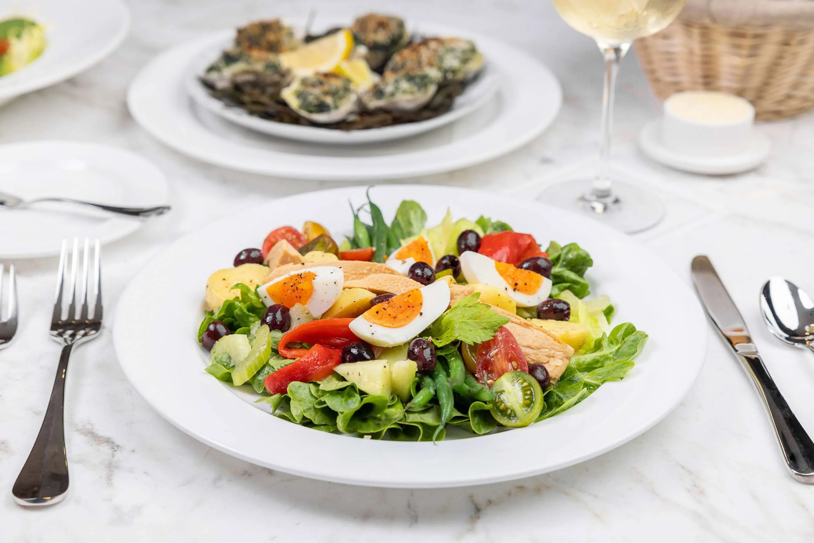 A beautifully plated Classic Niçoise Salad, a fresh appetizer from Stewart's restaurant menu at The Bedford.