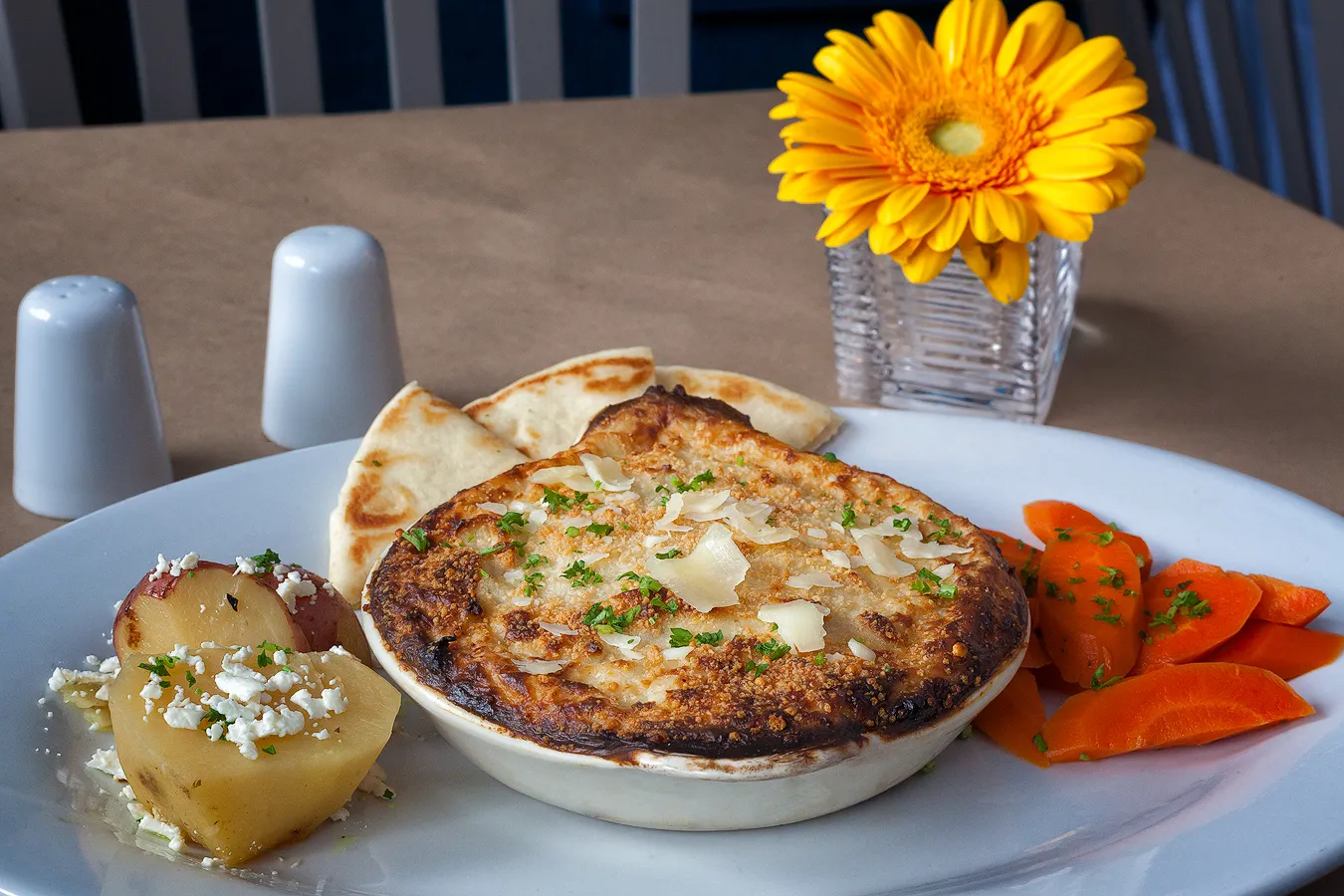 A hearty, golden-brown Beef Mousaka layered with meat sauce, eggplant, and thick béchamel