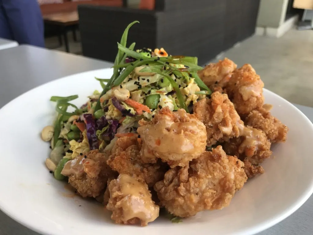 Vibrant Asian Shrimp Salad with crisp vegetables and golden-fried shrimp, reflecting the allintitle:moxie's restaurant menu
