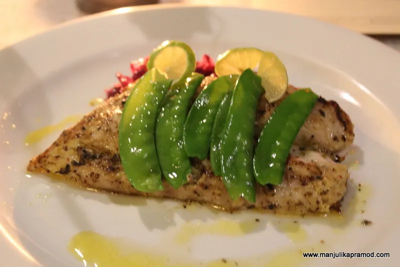 Pan-seared grouper with braised red cabbage and steamed snow peas, a farm to fork restaurant menu example
