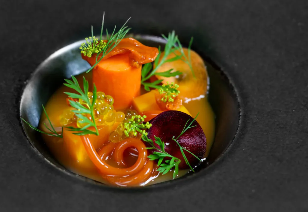 A close-up of the highly technical salt-baked, pickled, and spaghetti of heirloom carrot dish at Paris House