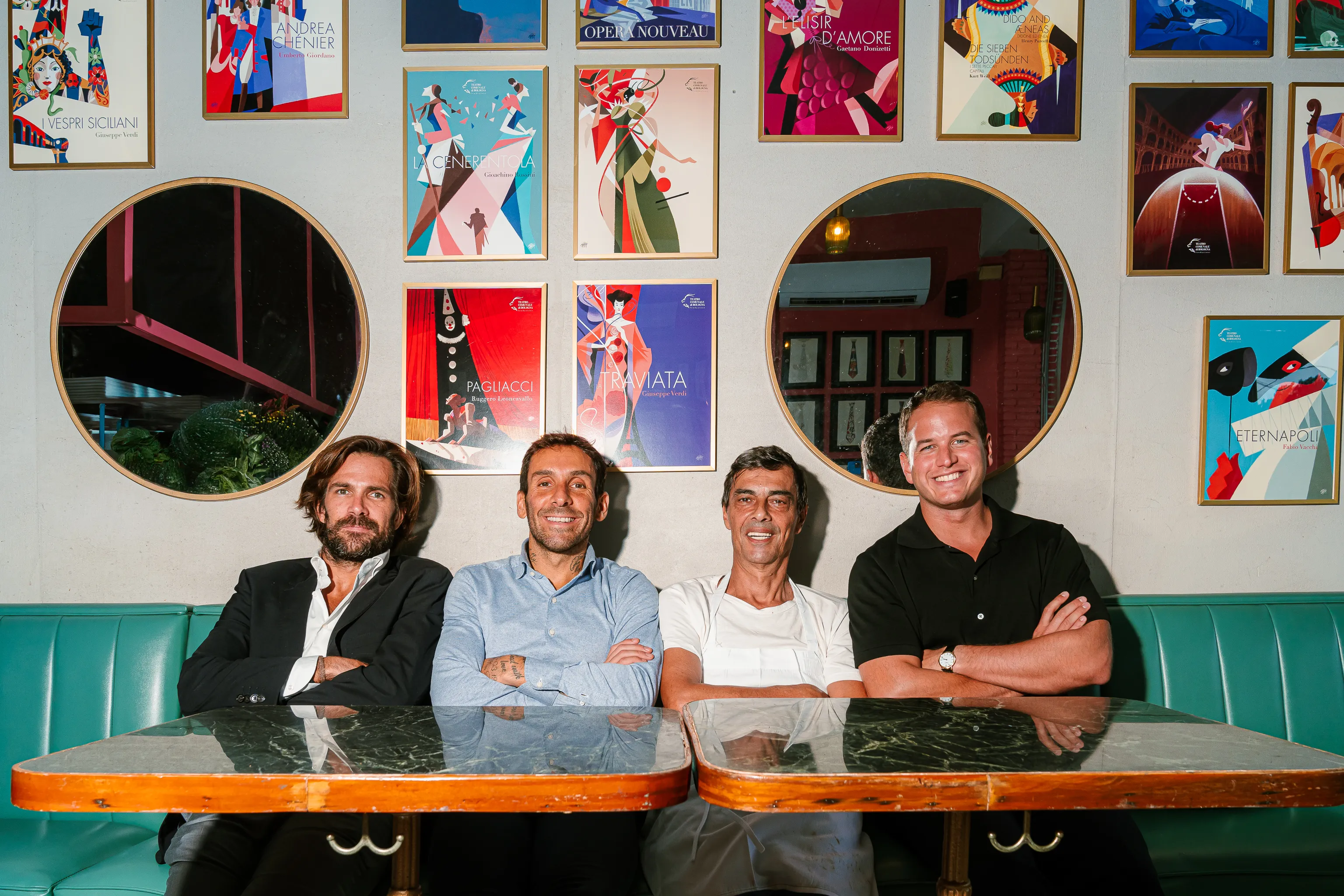 Ignacio Lopez, Andrea Fraquelli, Giulio Rossi, and Mattia Cicognani seated at a table and smiling.