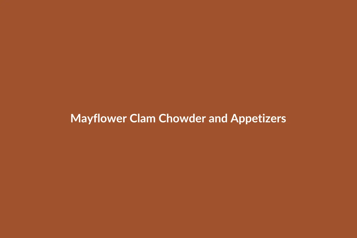 A delicious bowl of New England Clam Chowder with a side of crispy fried pickles