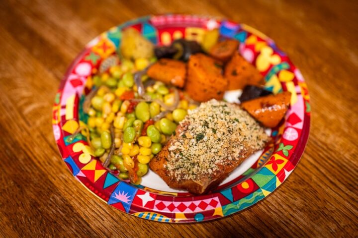 Panko-crusted salmon with roasted rainbow carrots and edamame succotash, demonstrating healthy options on a mega restaurant menu.