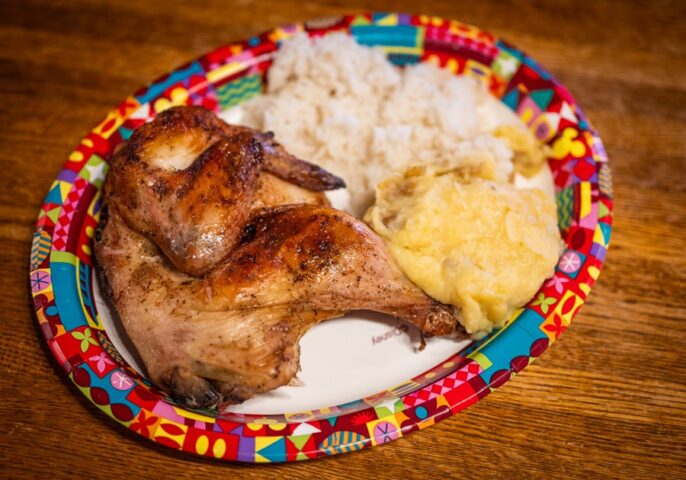 Mojo-roasted chicken entree with mashed potatoes and rice, a classic offering from an mega restaurant menu.