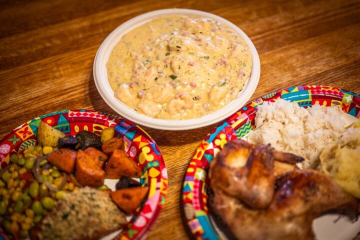 Freshly prepared shrimp and grits, showcasing live cooking stations and the diverse offerings of an mega restaurant menu.