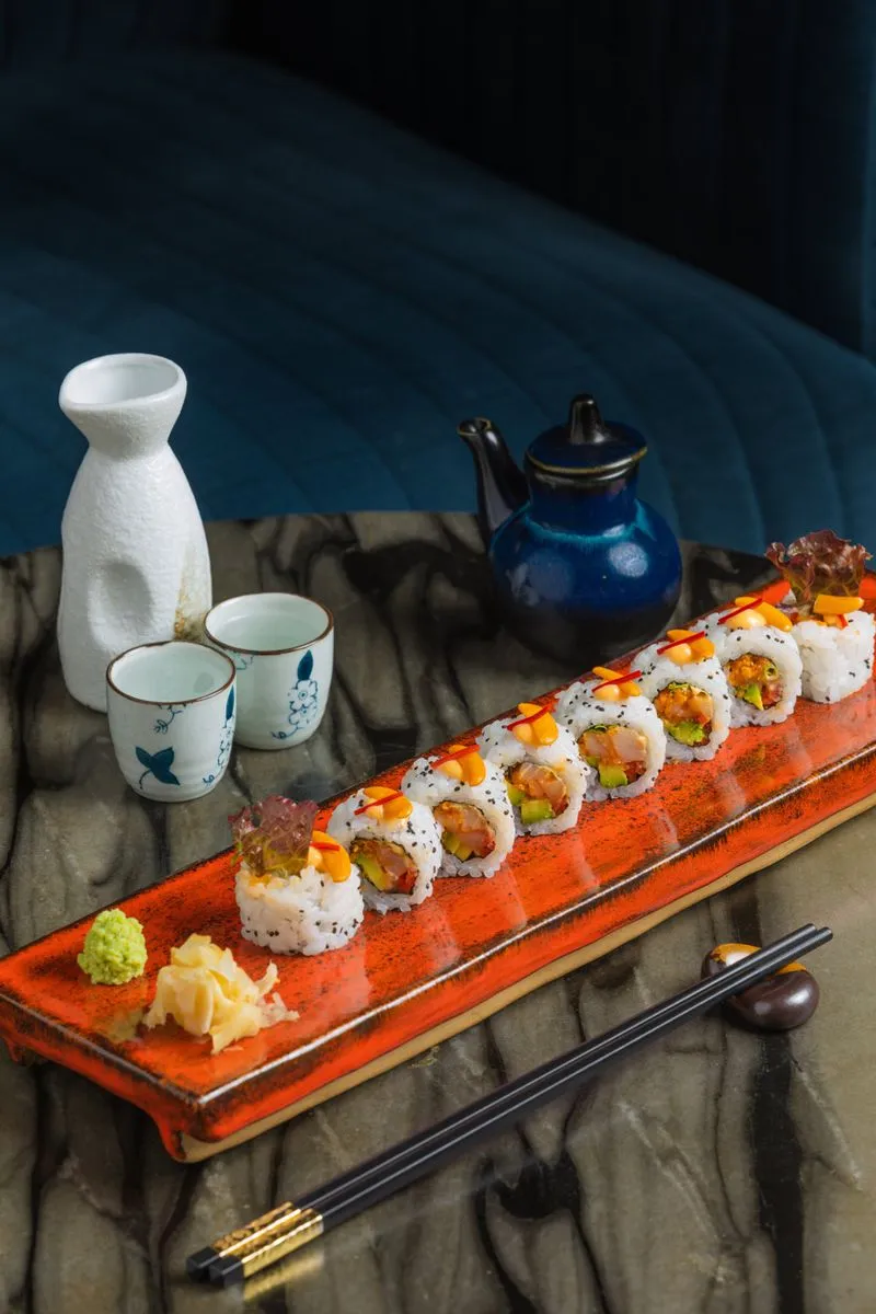 Alt text: A generous portion of the fresh Hamachi Maki roll served with ginger and wasabi