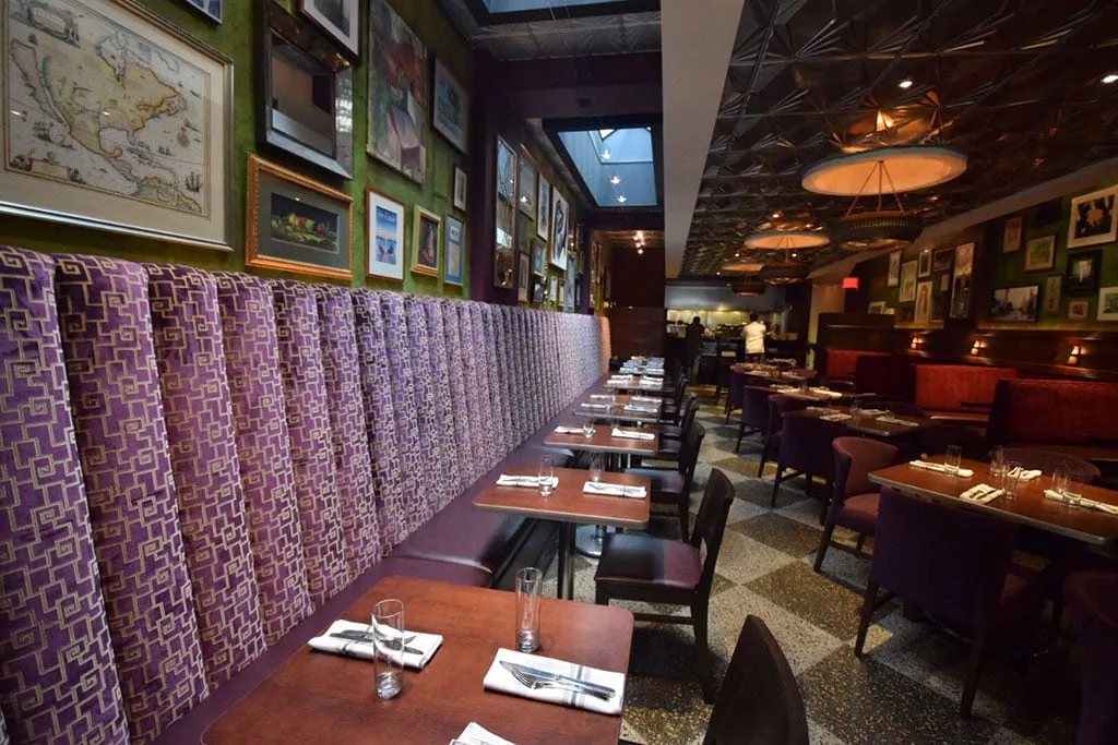 Funky purple booth seating under a skylight in the Art Deco redesign of The Majestic