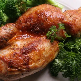 A perfectly roasted rotisserie half chicken, a comfort food classic on the Marion restaurant menu.