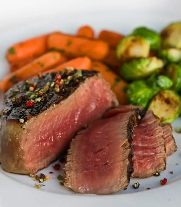 Sliced steak showing the perfect medium-rare interior and flavorful crust
