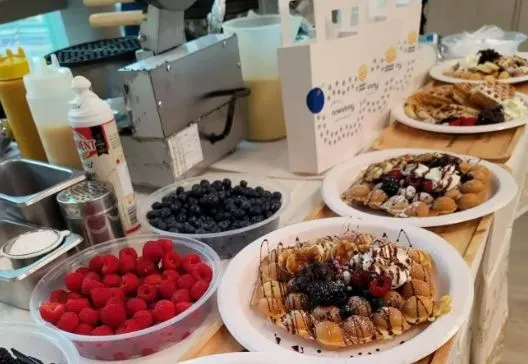 Hong Kong restaurant menu item featuring bubble waffles topped with fresh berries and chocolate sauce