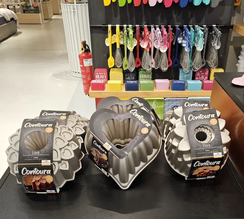 German Bundt pans on display in KaDeWe's kitchen equipment section, emphasizing the culture of baking