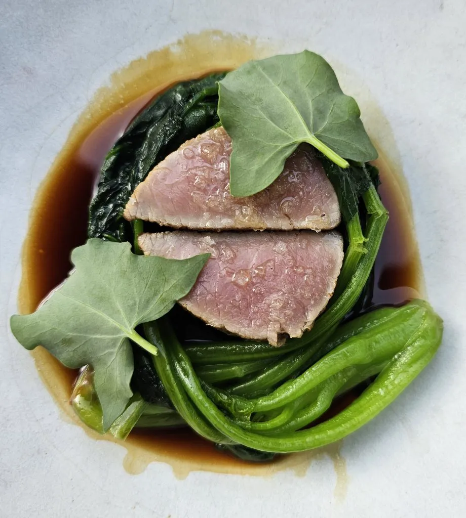 The main course of tender veal served with seasonal accompaniments at otto restaurant