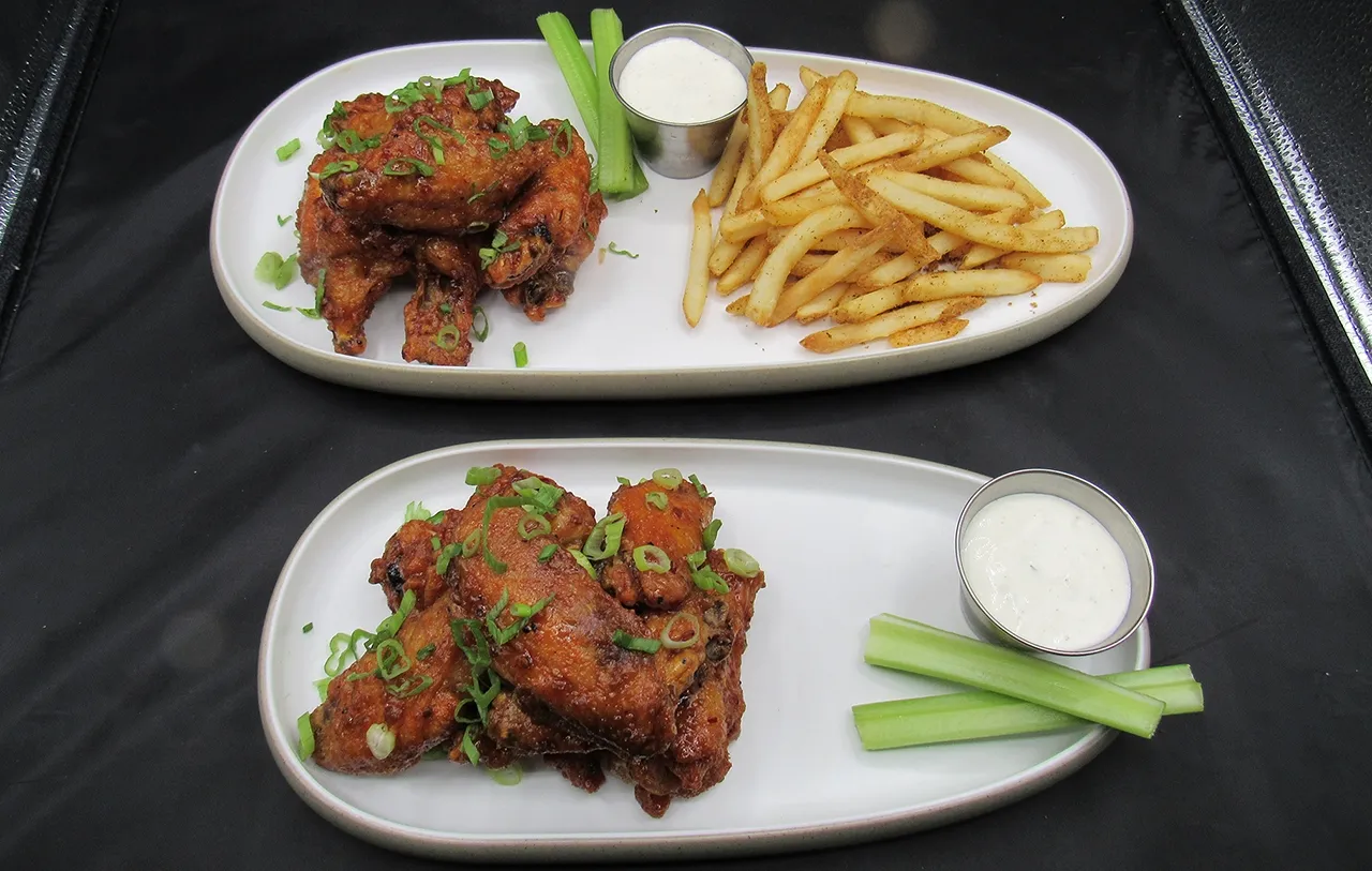 Dave & Buster's Kickin’ Chicken Potstickers with scallions, cilantro, and ponzu sauce, featuring chili crisp as a key element for the umami restaurant menu flavor boost