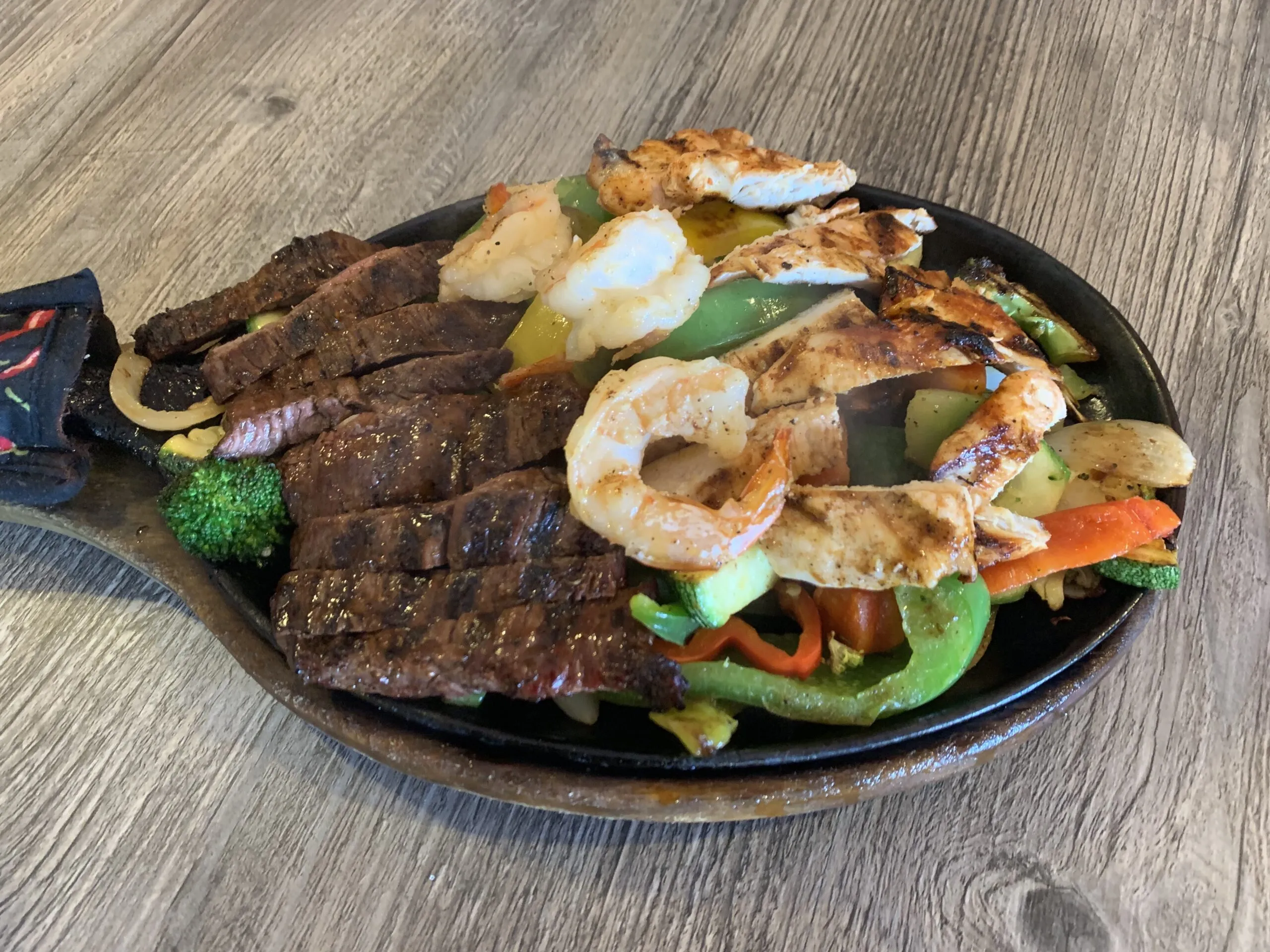 Trio Fajitas with steak, chicken, and shrimp on the tlaquepaque restaurant menu