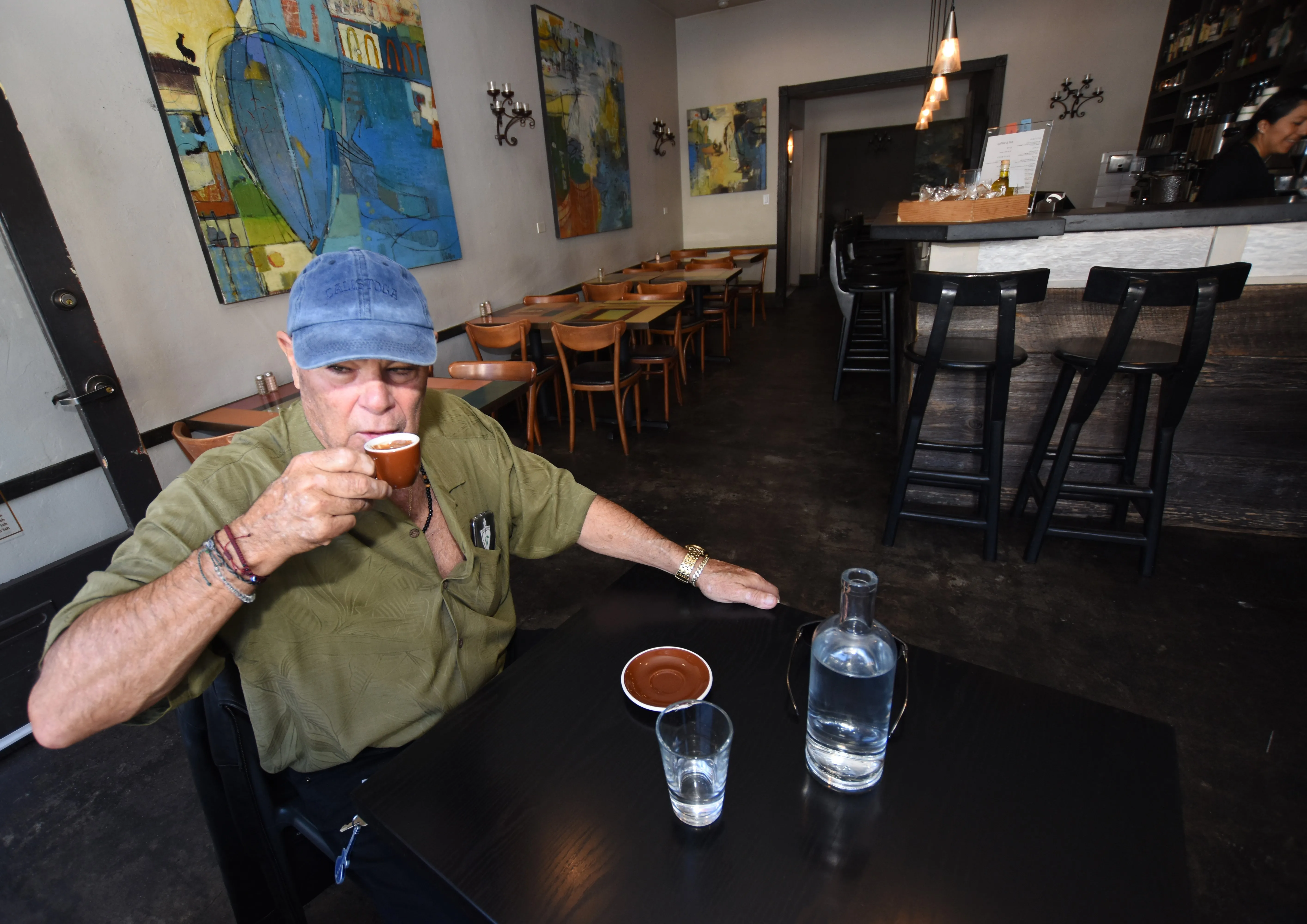 Regular customer enjoying coffee and the cozy atmosphere at the jazzy restaurant
