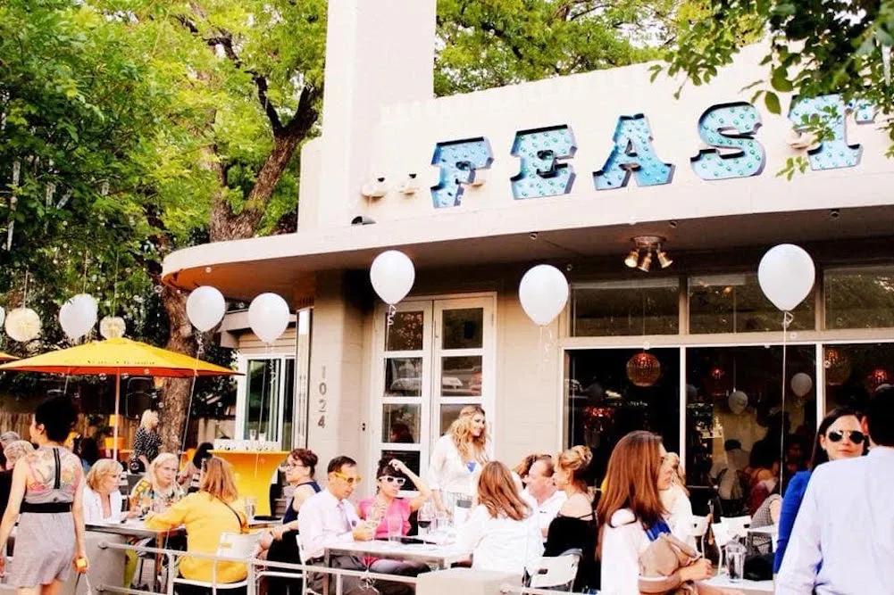 Outdoor diners at Feast enjoying the original menu, symbolizing the revive restaurant menu event